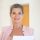 Smiling professional woman in pink blazer holding documents