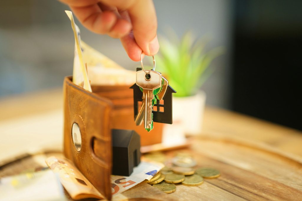 Hand hold door keys new home household expense bills wallet